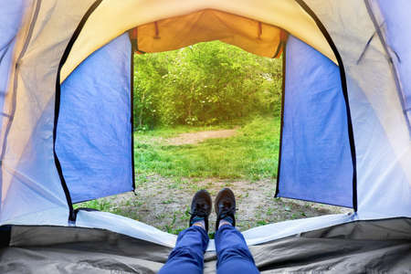 Woman lying in camping tentの写真素材