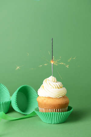 Tasty Birthday cupcake on color backgroundの写真素材