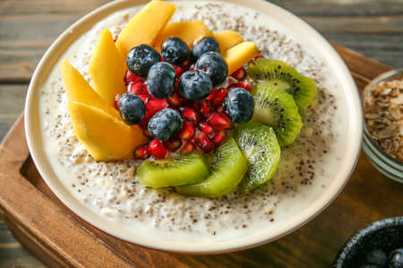 Bowl with tasty chia dessert on wooden boardの写真素材