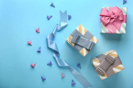 Beautiful gift boxes and flowers on color backgroundの写真素材