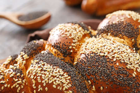 Tasty bun with poppy seeds, closeup