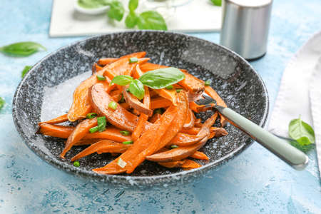 Plate with tasty cooked sweet potato on table