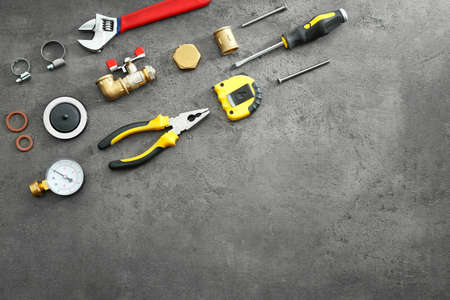 Set of plumber tools on grunge background