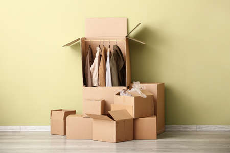 Wardrobe boxes with clothes near color wallの写真素材