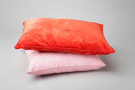 Stylish pillows on gray background