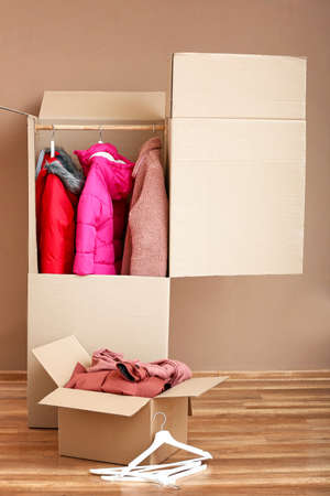 Wardrobe boxes with clothes near color wallの写真素材