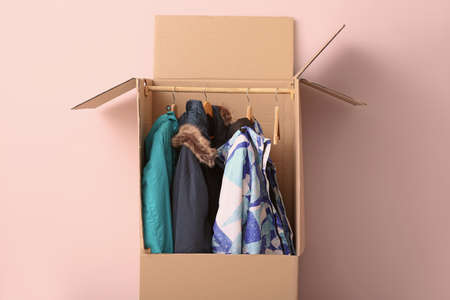 Wardrobe box with clothes on white background