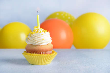 Tasty Birthday cupcake on gray table
