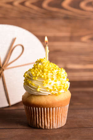 Tasty Birthday cupcake on wooden backgroundの写真素材