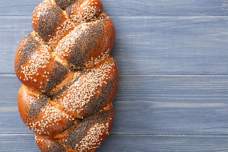 Tasty bun with poppy seeds on tableの写真素材