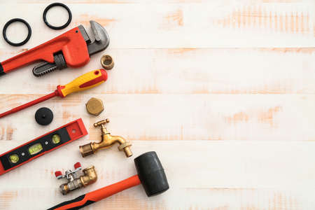 Set of plumbing tools on white wooden backgroundの写真素材