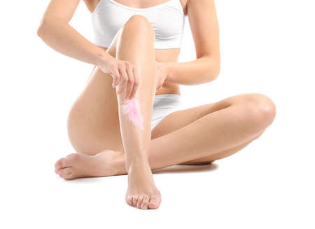 Beautiful young woman with smooth skin after depilation on white background