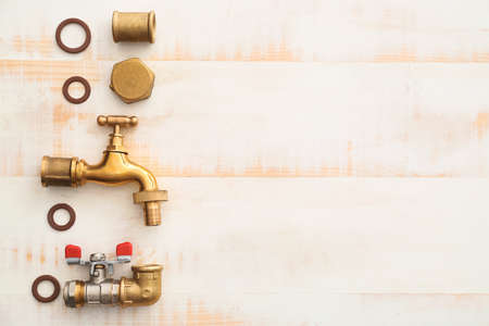 Set of plumbing items on white wooden background