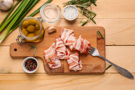 Composition with fresh raw bacon on wooden background