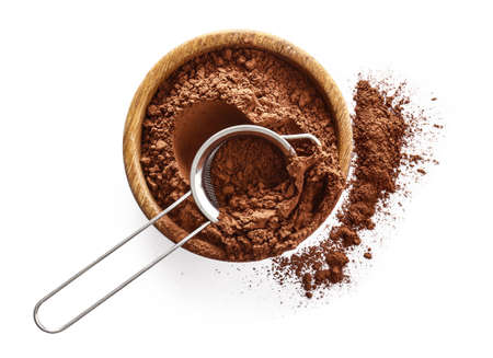 Bowl with cocoa powder and sieve on white backgroundの写真素材
