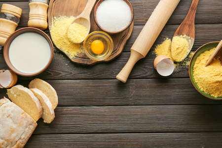 Flour with products on wooden table