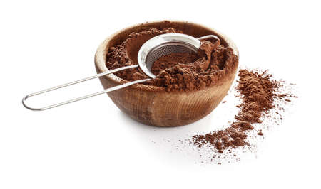 Bowl with cocoa powder and sieve on white backgroundの写真素材