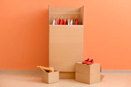 Wardrobe boxes with clothes near color wallの写真素材