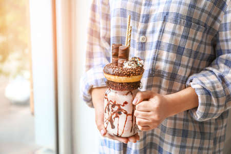 Young woman with delicious freak shake, closeupの写真素材