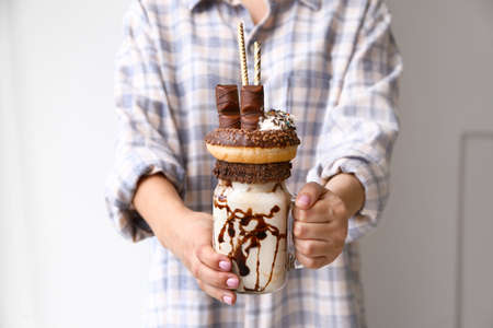 Young woman with delicious freak shake, closeupの写真素材