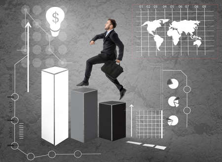 Businessman with briefcase running upstairs on gray backgroundの写真素材