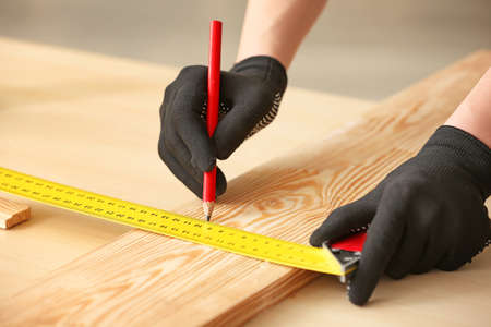 Female carpenter working in shop, closeupの写真素材