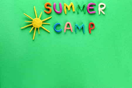 Text SUMMER CAMP and sun made of plasticine on color backgroundの写真素材