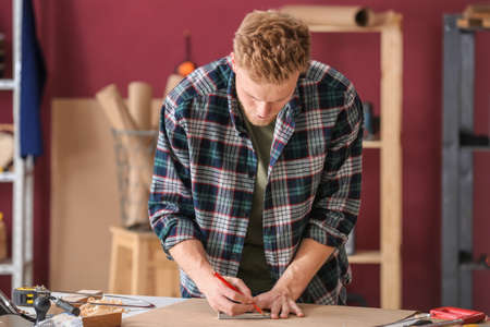 Male carpenter working in shopの写真素材