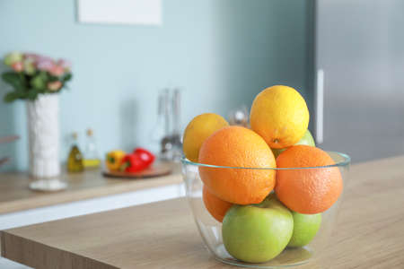 Bowl with fresh fruits on table in kitchenの写真素材