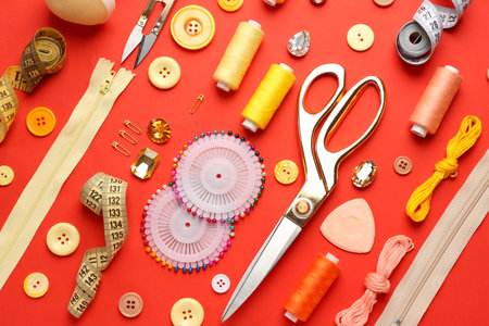 Set of sewing threads and accessories on color background