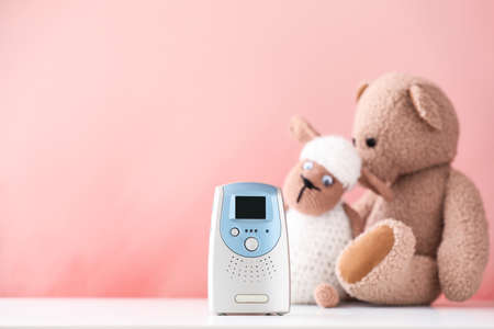 Modern baby monitor and toys on table