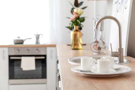 Plate and cups on kitchen counterの写真素材