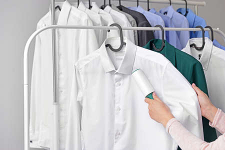Woman removing dirt from clothes at dry-cleaner's