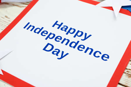 Card with text HAPPY INDEPENDENCE DAY on wooden table, closeupの写真素材