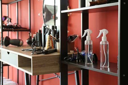 Hairdresser tools on shelves and table in beauty salonの写真素材