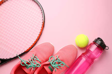 Tennis racket, shoes, bottle of water and ball on color backgroundの写真素材