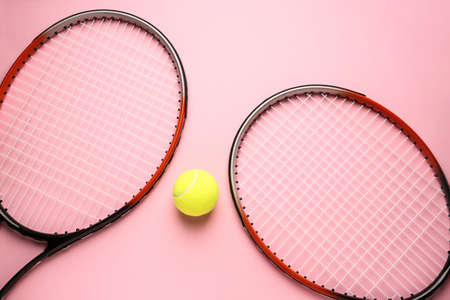 Tennis rackets and ball on color backgroundの写真素材