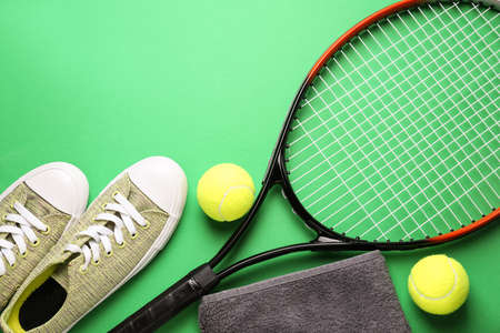 Tennis racket, shoes, towel and balls on color backgroundの写真素材