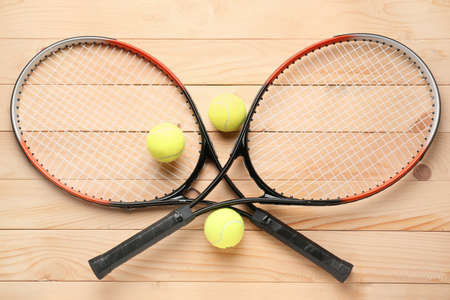 Tennis rackets and balls on wooden backgroundの写真素材