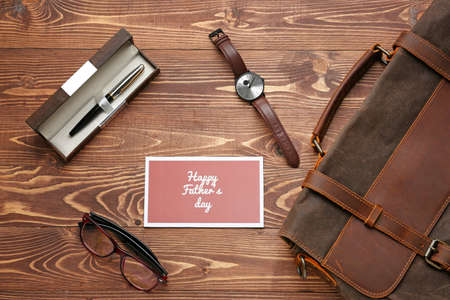 Male accessories and card with text HAPPY FATHER'S DAY on wooden backgroundの写真素材