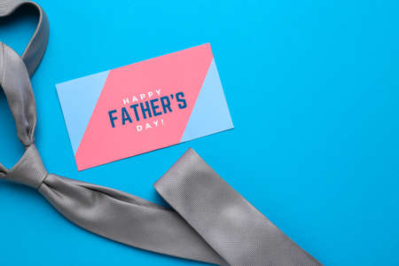 Necktie and card with text HAPPY FATHER'S DAY on color backgroundの写真素材
