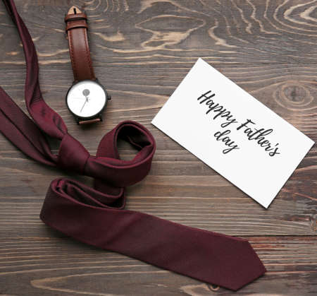 Male accessories and card with text HAPPY FATHER'S DAY on wooden backgroundの写真素材