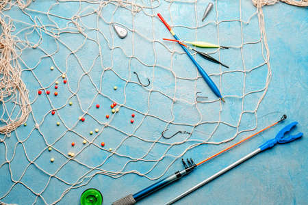 Different fishing accessories on light backgroundの写真素材