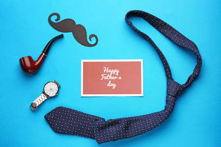 Male accessories and card with text HAPPY FATHER'S DAY on color backgroundの写真素材