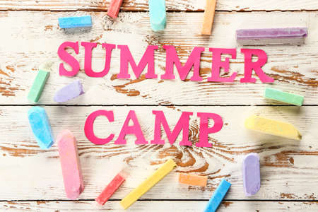 Words SUMMER CAMP and crayons on wooden backgroundの写真素材