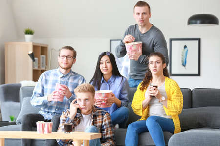 Friends watching TV at home