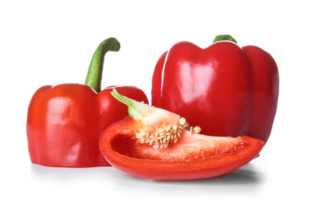 Ripe red peppers on white background