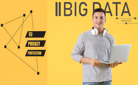 Male programmer with laptop on color background