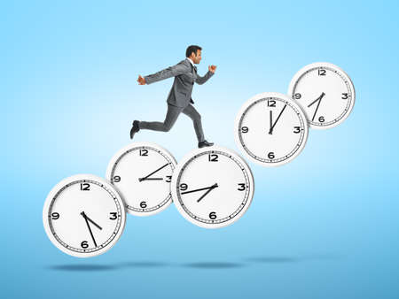 Running young businessman with clocks on color background. Deadline concept