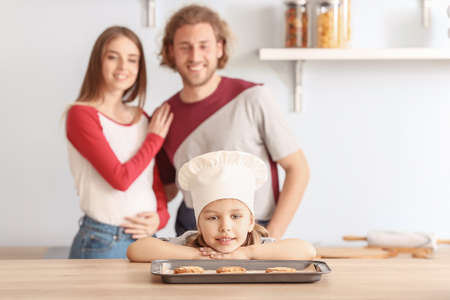 Little girl and her parents baking pastry at homeの写真素材